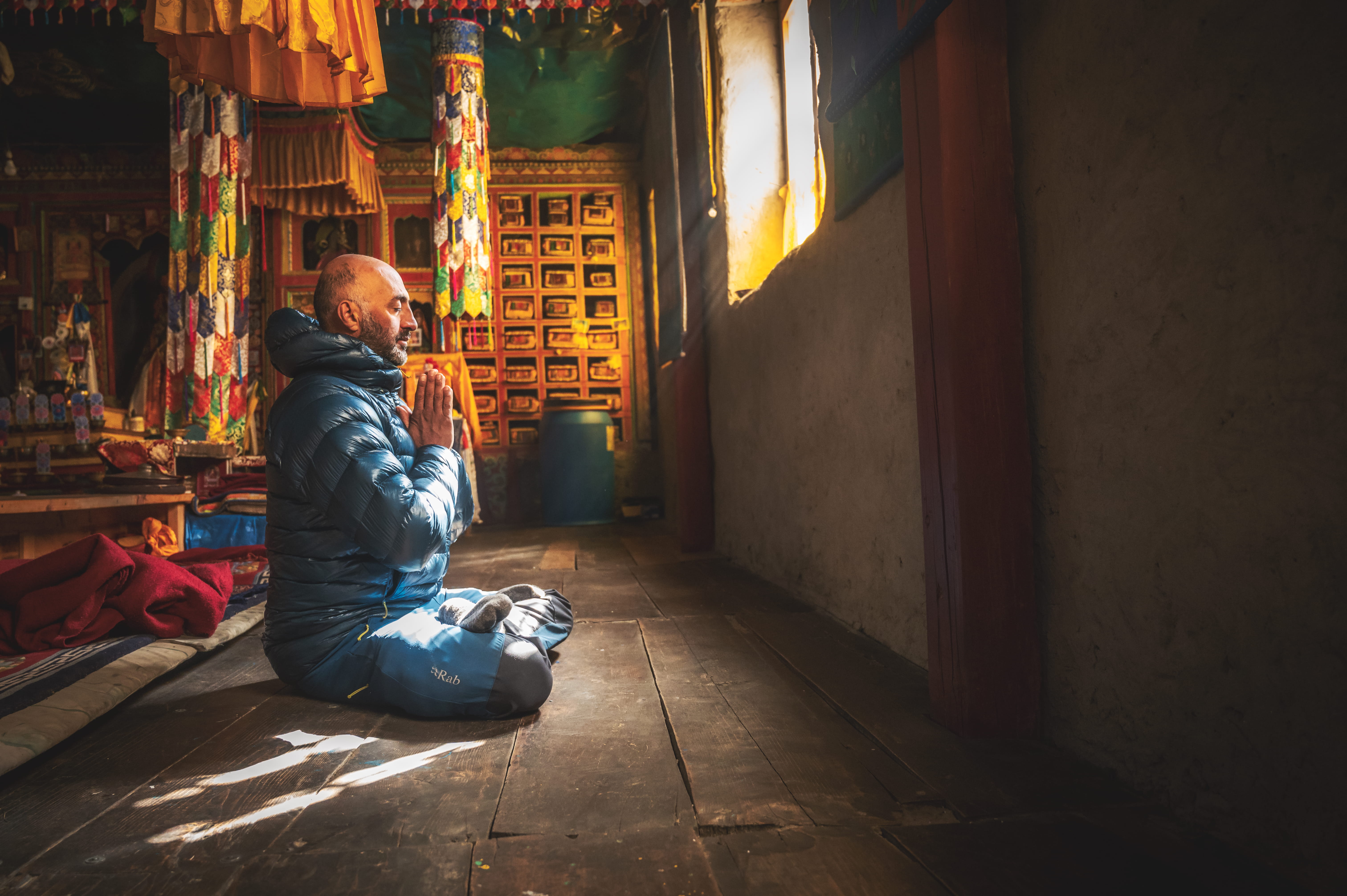 Mostafa praying in a Buddhist monastery in Nepal