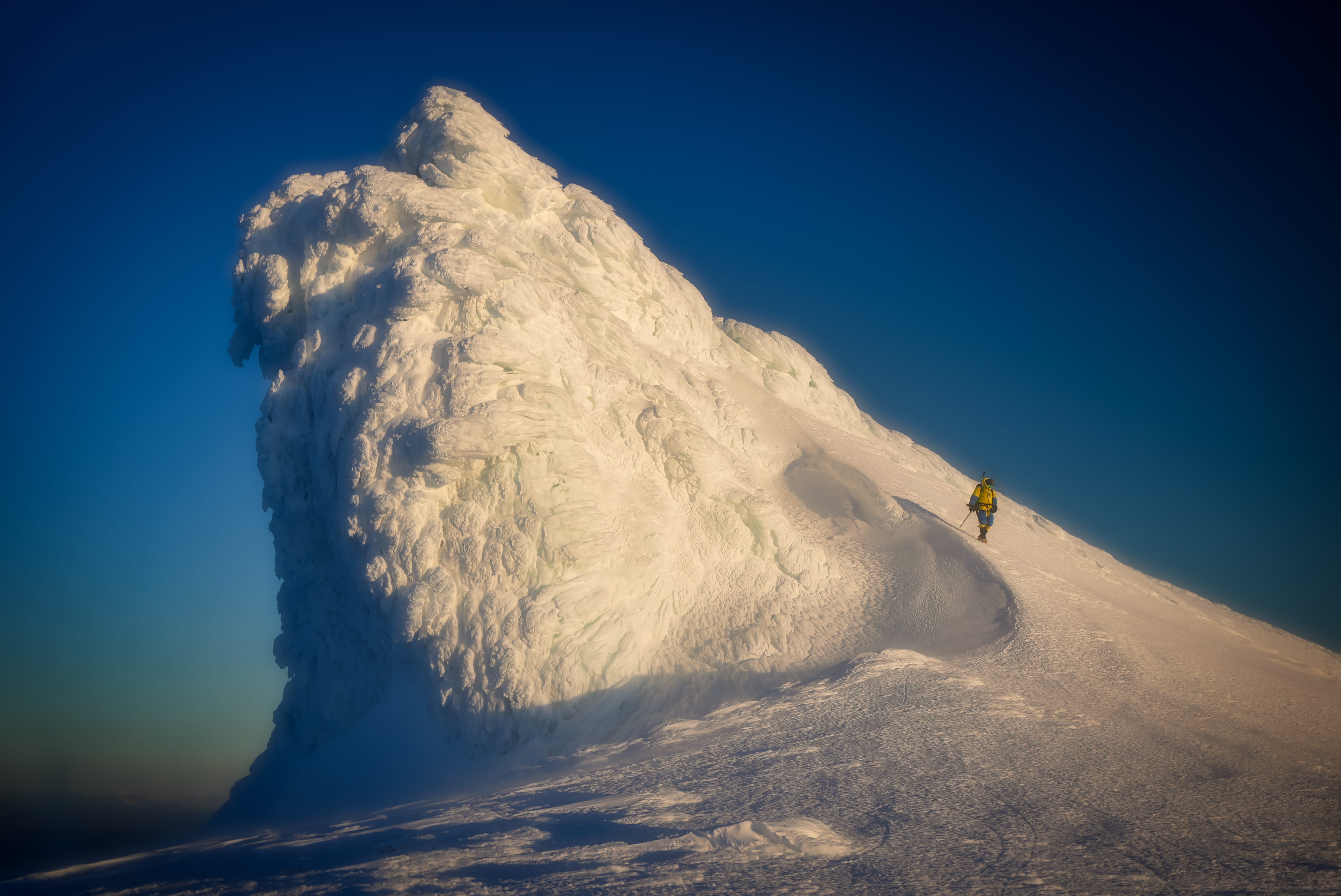 Climber approaching a giant snow formation