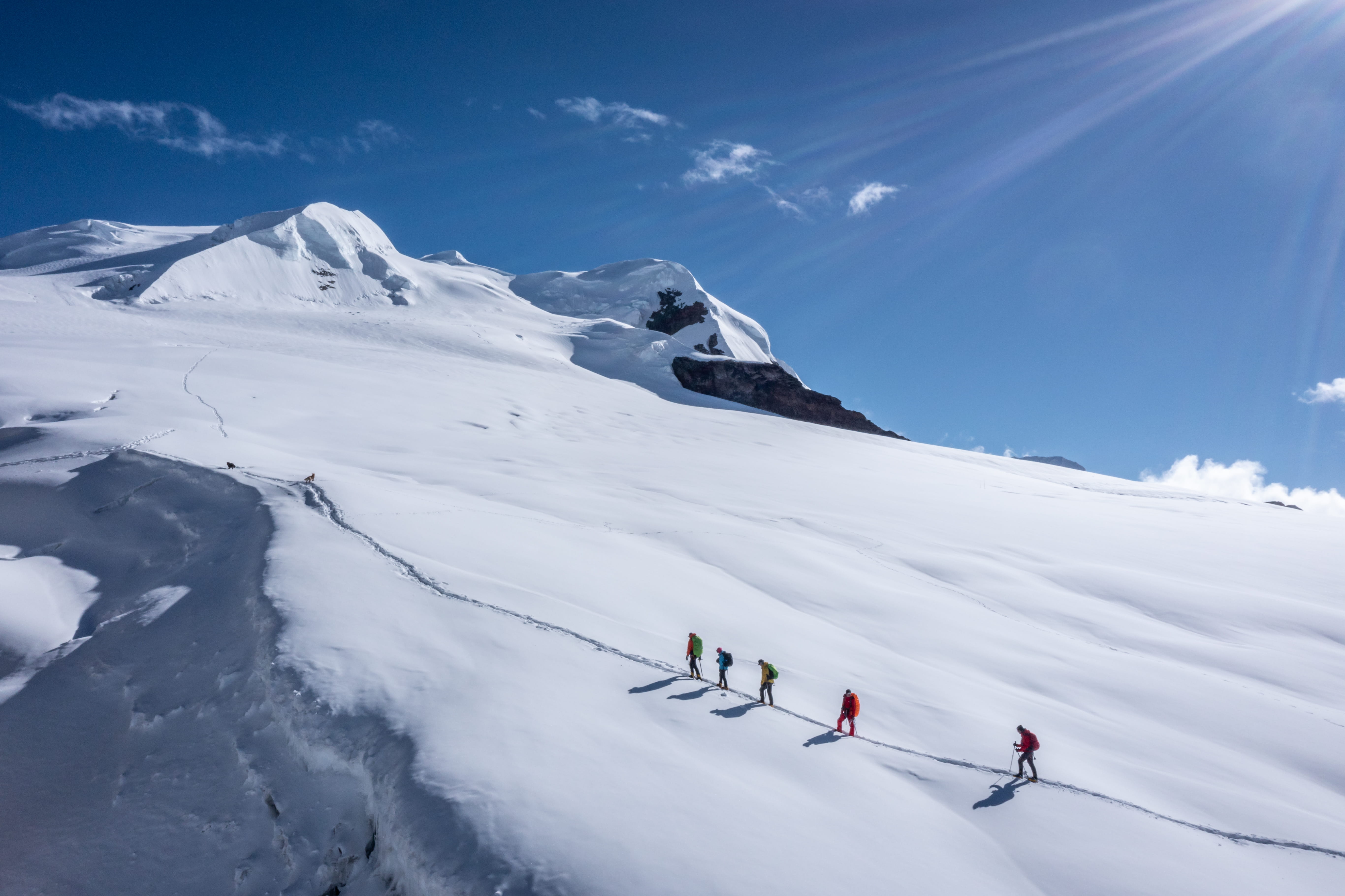 Roped expedition team crossing a snowfield